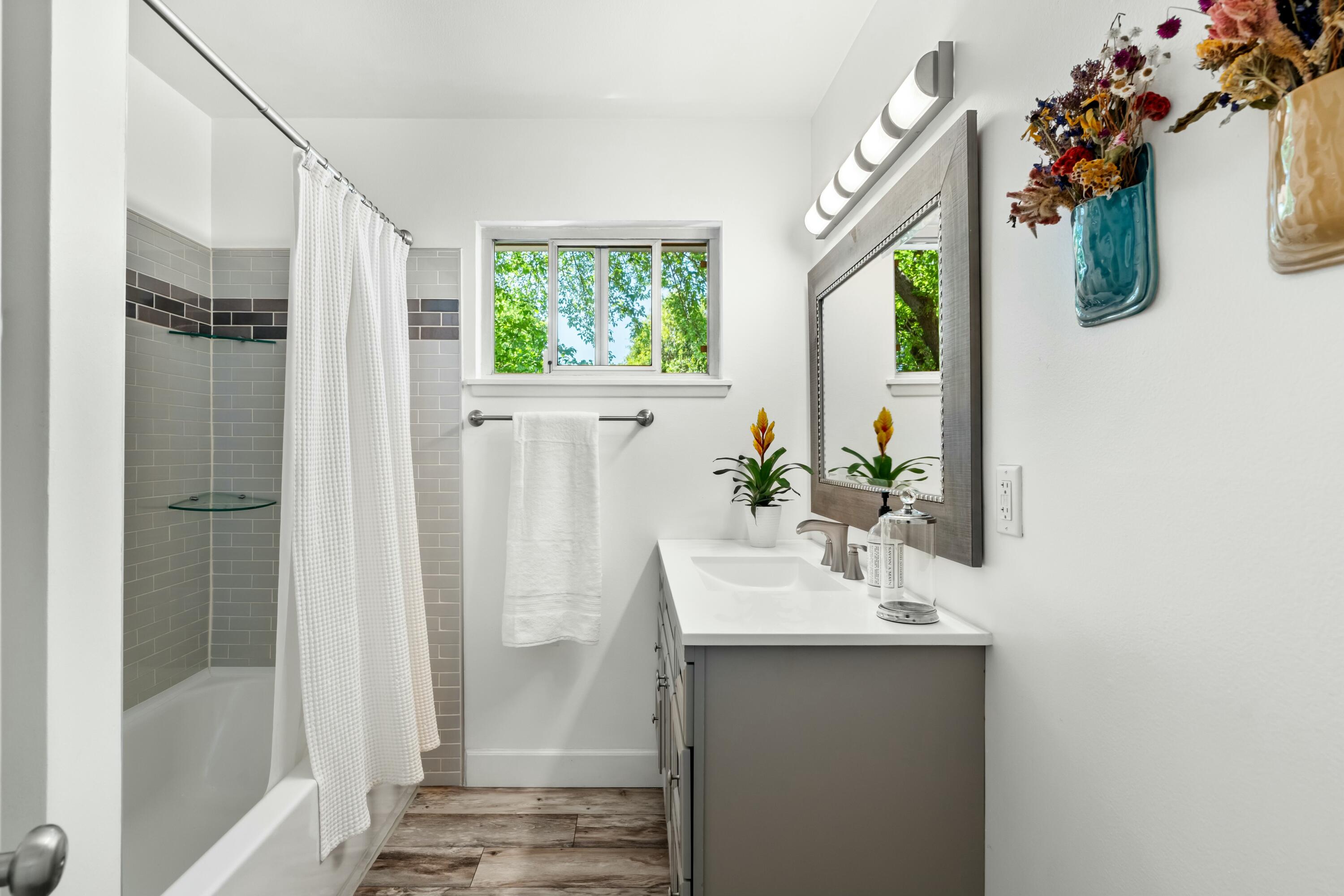 6860 Riata Drive Redding, CA 96002 - Photo 16 of 39 a bathroom with a sink a mirror and a window
