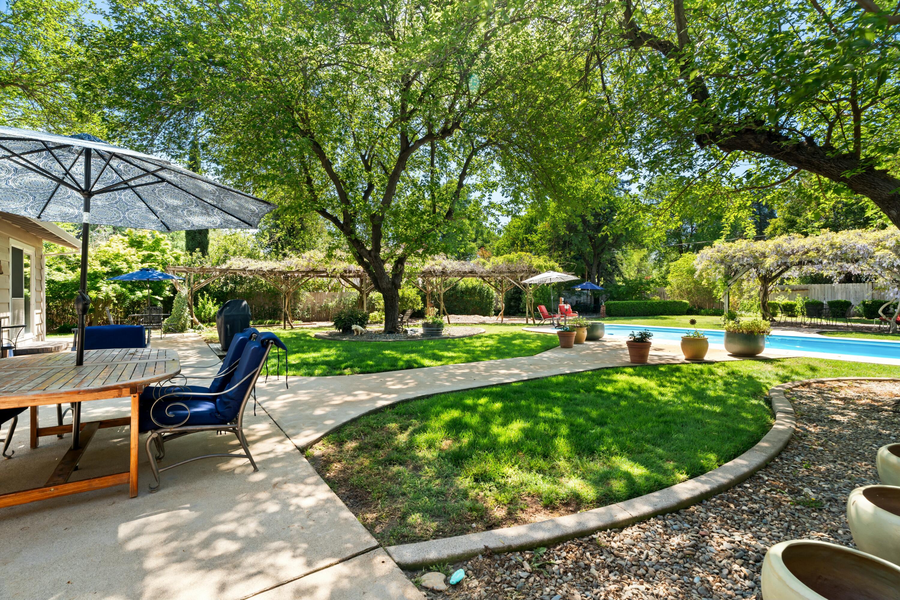 6860 Riata Drive Redding, CA 96002 - Photo 30 of 39 a view of a swimming pool with a patio
