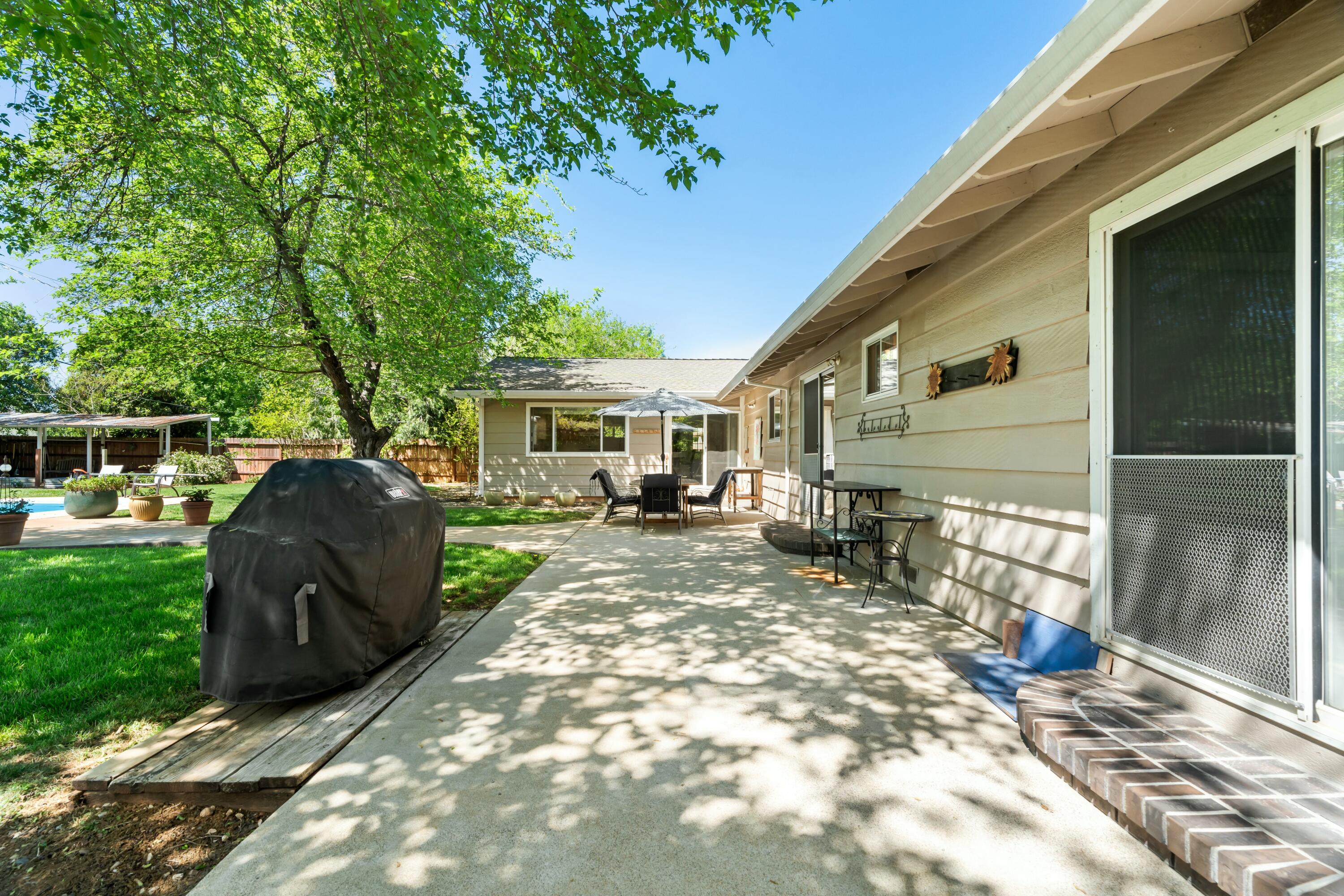 6860 Riata Drive Redding, CA 96002 - Photo 34 of 39 a view of a house with backyard and sitting area