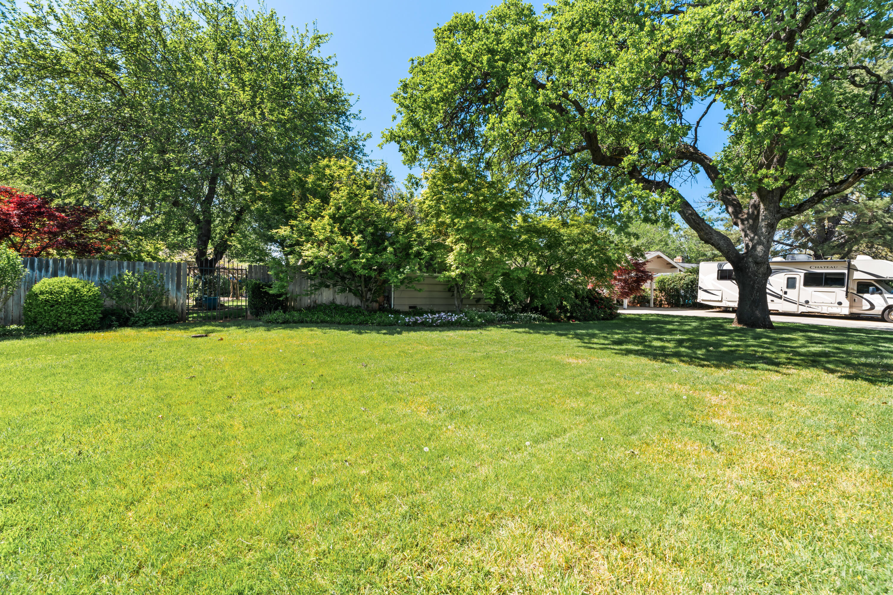 6860 Riata Drive Redding, CA 96002 - Photo 4 of 39 a view of a yard with a house
