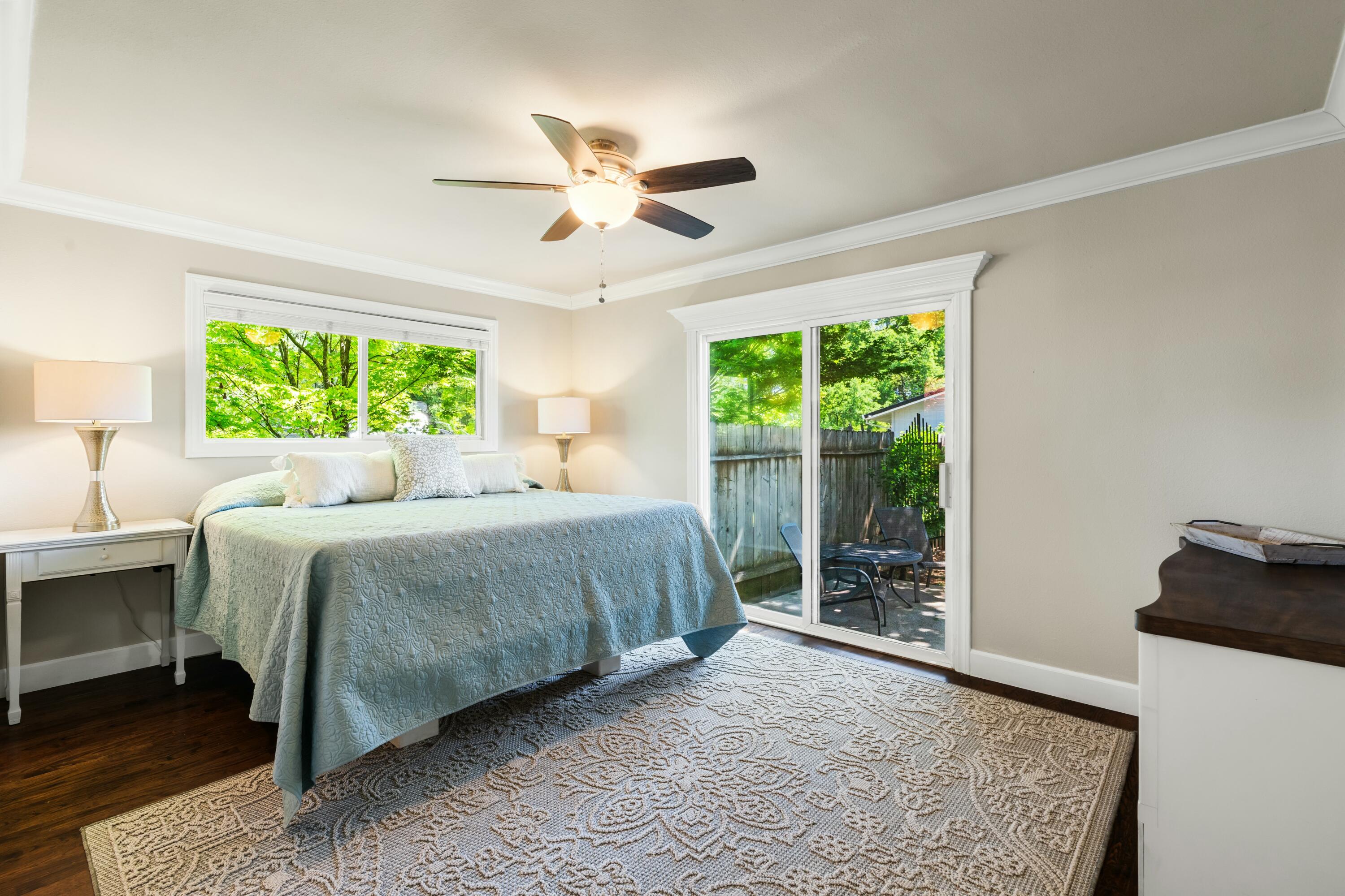 6860 Riata Drive Redding, CA 96002 - Photo 9 of 39 a spacious bedroom with a large bed and a chandelier