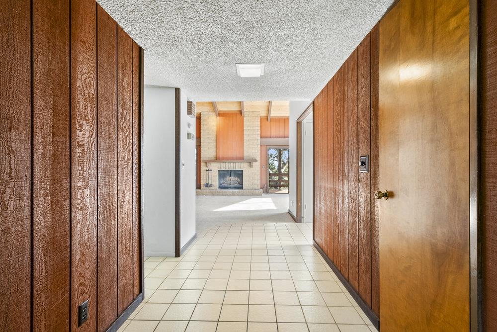 14104 Reservation Road Salinas, CA 93908 - Photo 11 of 56 a view of a hallway with wooden floor and staircase