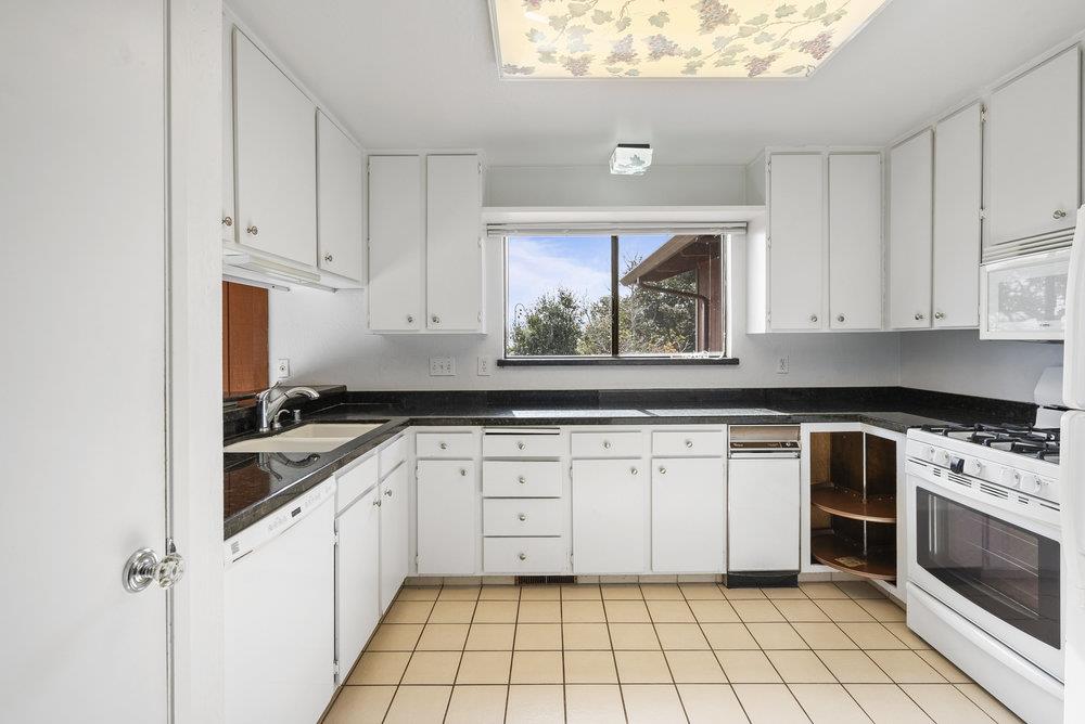 14104 Reservation Road Salinas, CA 93908 - Photo 20 of 56 a kitchen with a stove sink and cabinets