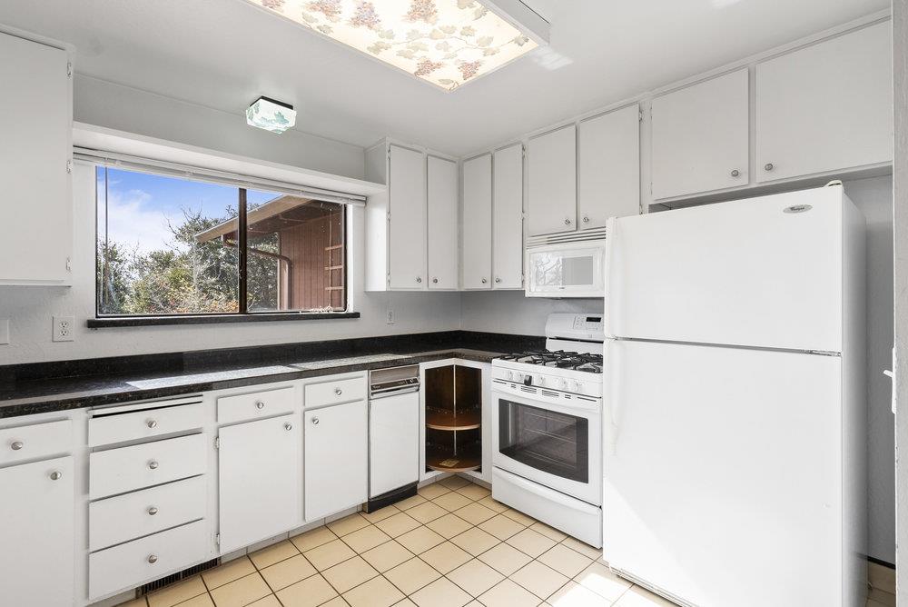 14104 Reservation Road Salinas, CA 93908 - Photo 22 of 56 a white refrigerator freezer sitting inside of a kitchen