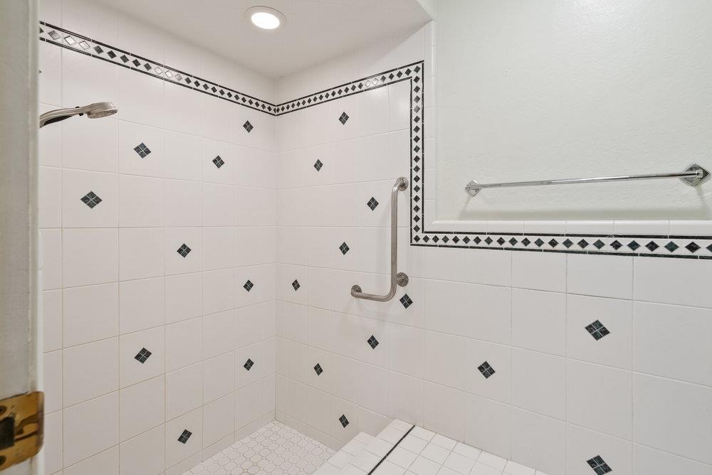 14104 Reservation Road Salinas, CA 93908 - Photo 28 of 56 a bathroom with a glass shower door