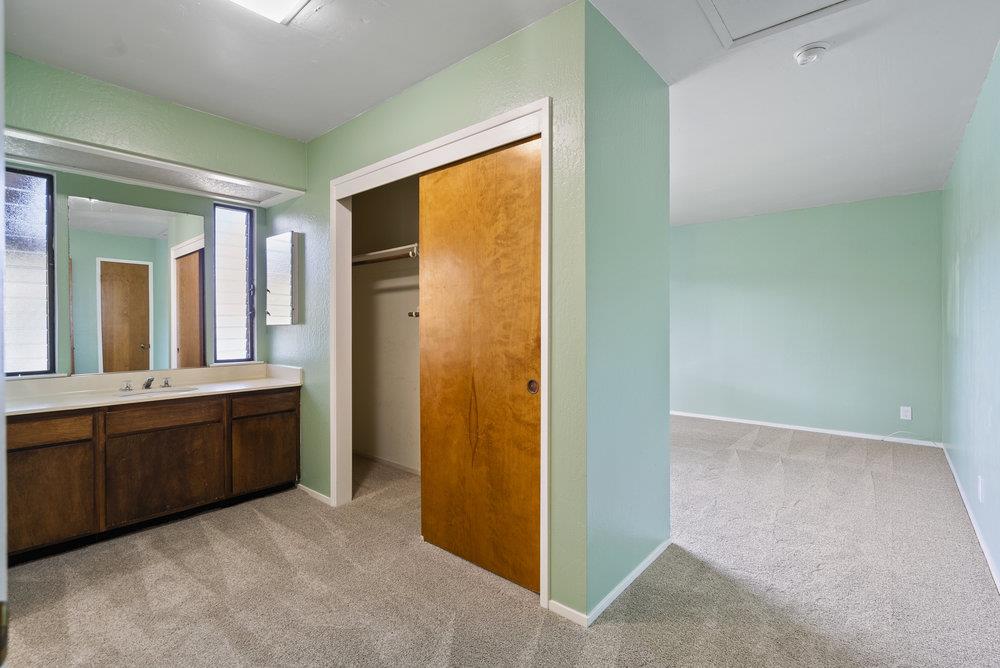 14104 Reservation Road Salinas, CA 93908 - Photo 38 of 56 a spacious bathroom with a granite countertop sink and a mirror