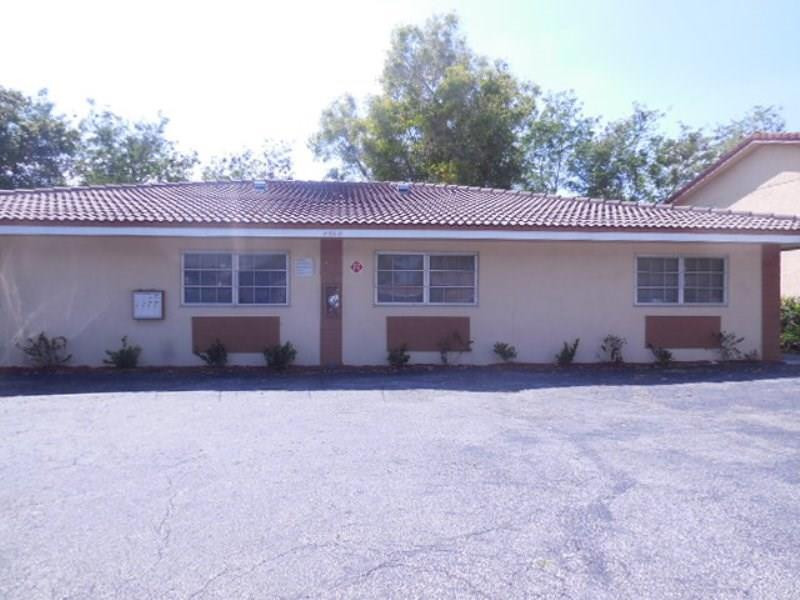 4020 Riverside Drive Coral Springs, FL 33065 - Photo 1 of 1 a house that has a tree in front of it