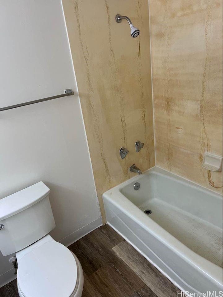 1112 Kinau Street, Unit 506 Honolulu, HI 96814 - Photo 11 of 12 a bathroom with a toilet and a bath tub