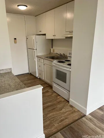 a view of a livingroom with wooden floor and fireplace