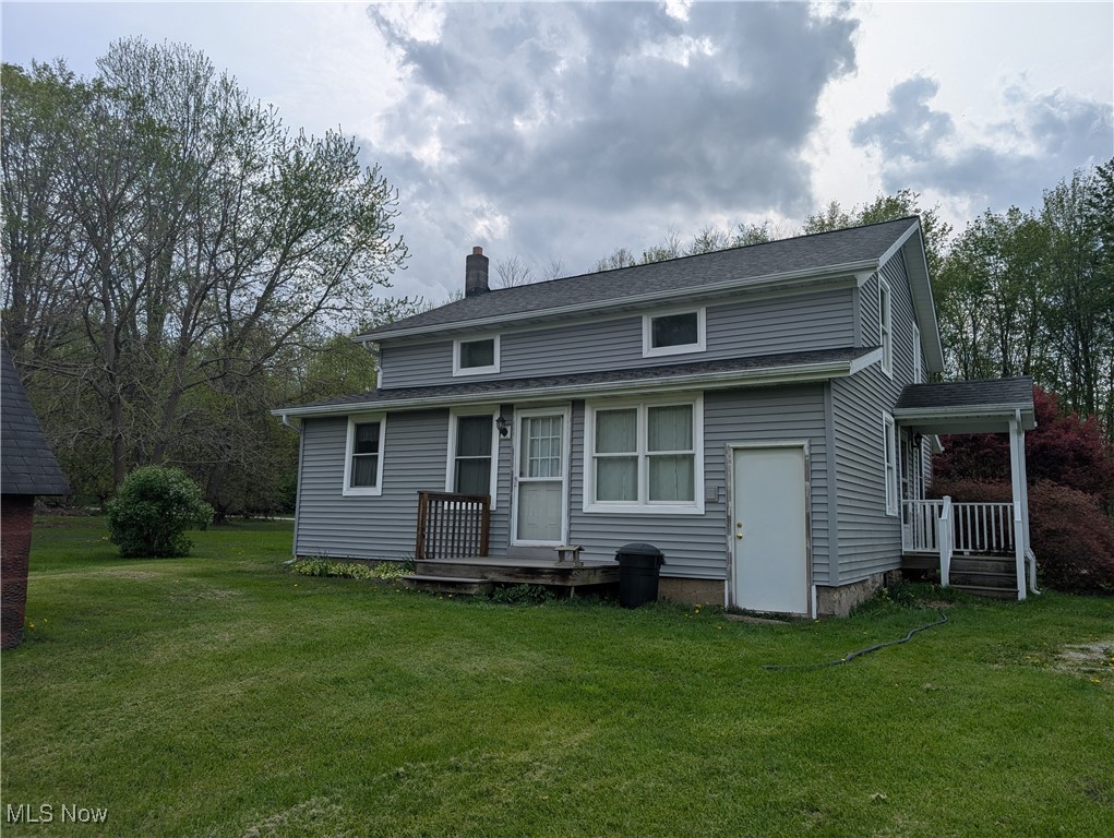 2356 Walter Main Road Geneva, OH 44041 - Photo 8 of 27 Back of house with a lawn, a chimney, and a shingled roof