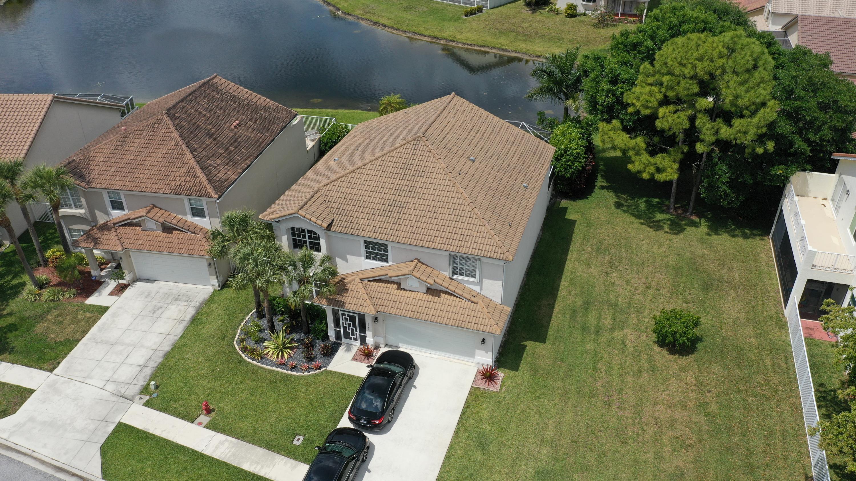18243 Blue Lake Way Boca Raton, FL 33498 - Photo 5 of 47 AERIAL OF HOUSE, LAKE, & SIDE YARD