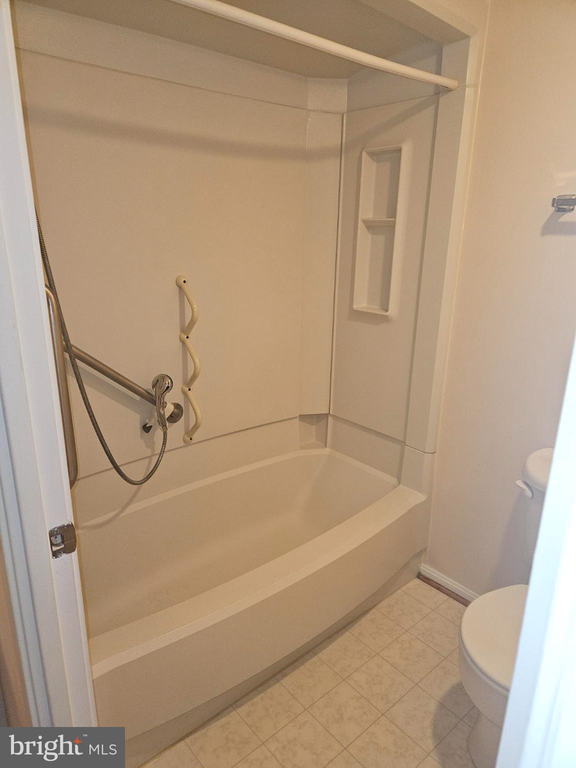15107 Interlachen Drive, Unit 2815 Silver Spring, MD 20906 - Photo 27 of 35 a bathroom with a bathtub and a shower