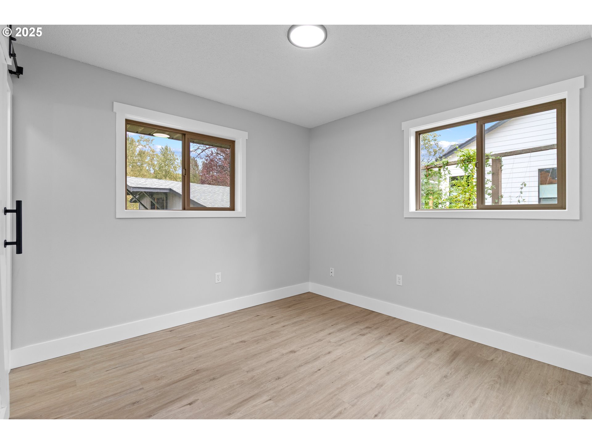 2859 Northeast 2nd Avenue Camas, WA 98607 - Photo 21 of 48 a view of an empty room with wooden floor and windows