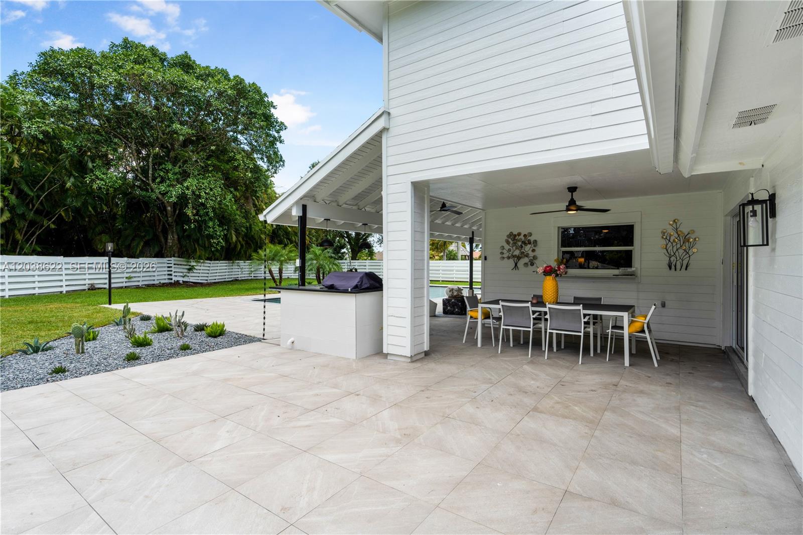 14830 Southwest 149th Street Miami, FL 33196 - Photo 22 of 43 a view of a chairs and table in backyard room