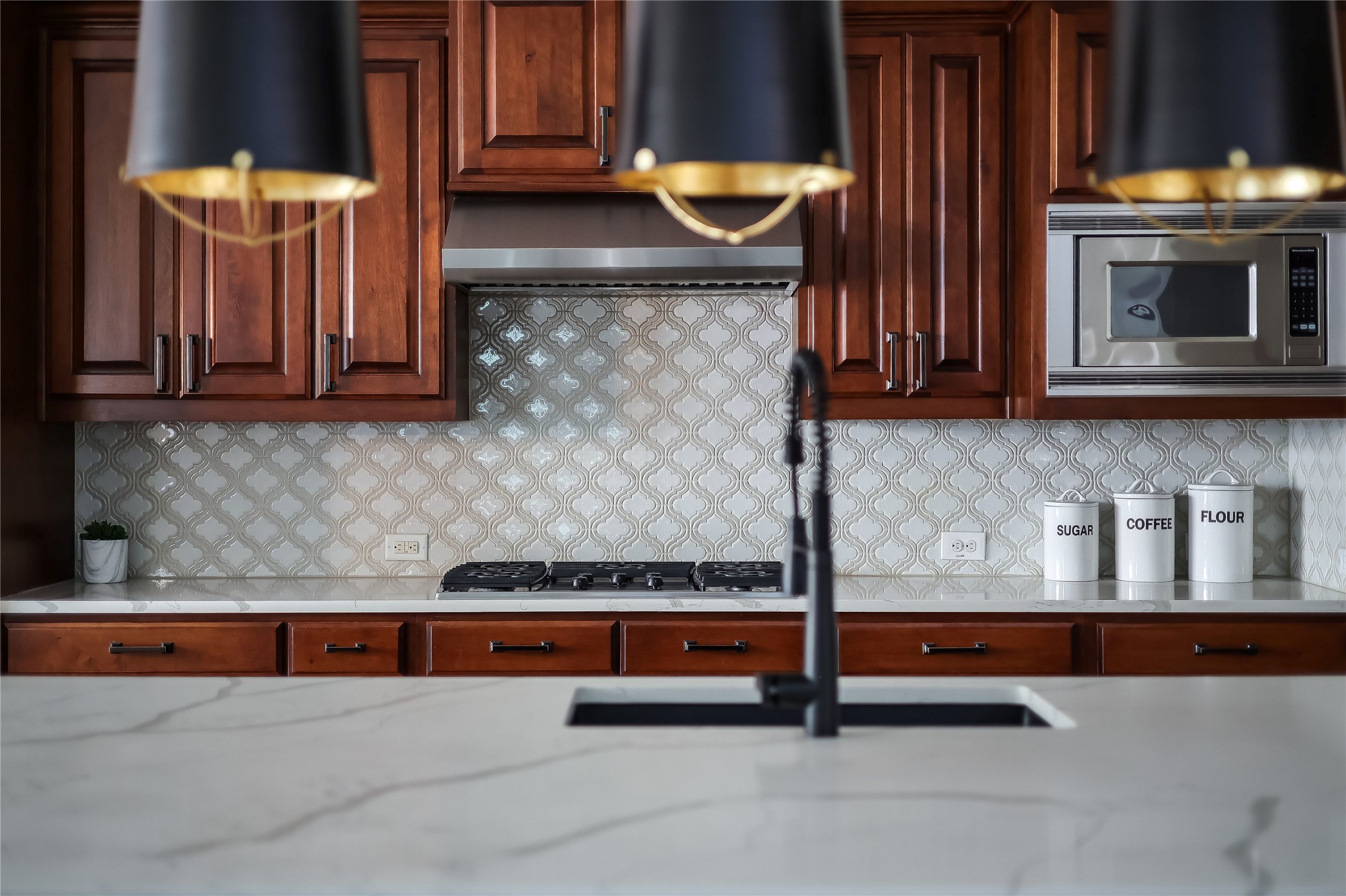 401 Bluff View Road Cedar Park, TX 78613 - Photo 20 of 40 Culinary aspirations meet sophisticated design in this kitchen, featuring rich cabinetry and a functional island.