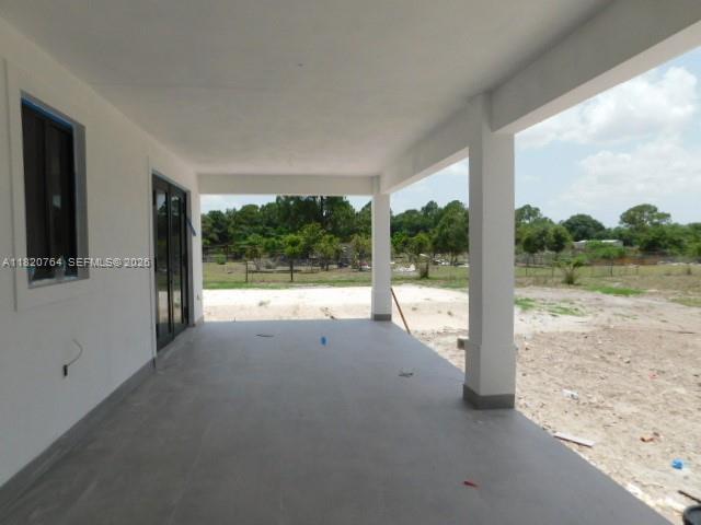 160 North Isora Street Clewiston, FL 33440 - Photo 12 of 26 a view of an empty room with a floor to ceiling window and a yard