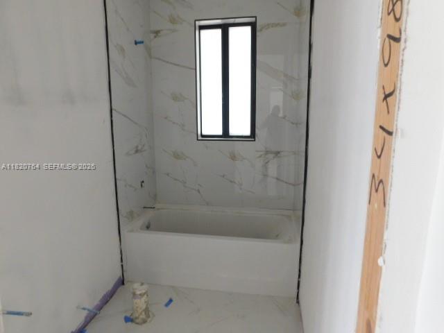 160 North Isora Street Clewiston, FL 33440 - Photo 7 of 26 a bathroom with a bathtub and shower