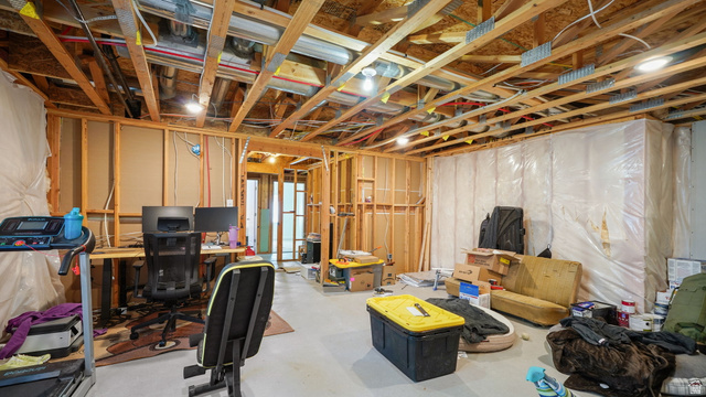 6062 Spring Street Stansbury Park, UT 84074 - Photo 26 of 36 Unfinished basement office offering substantial potential for customization, featuring exposed wooden ceiling joists, framed wall partitions, and an open layout