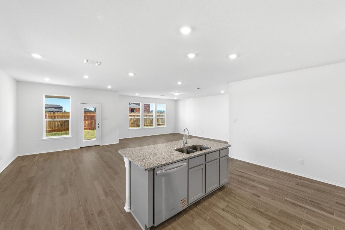 Undisclosed Address Manor, TX 78653 - Photo 14 of 31 a kitchen with a sink and wooden floor
