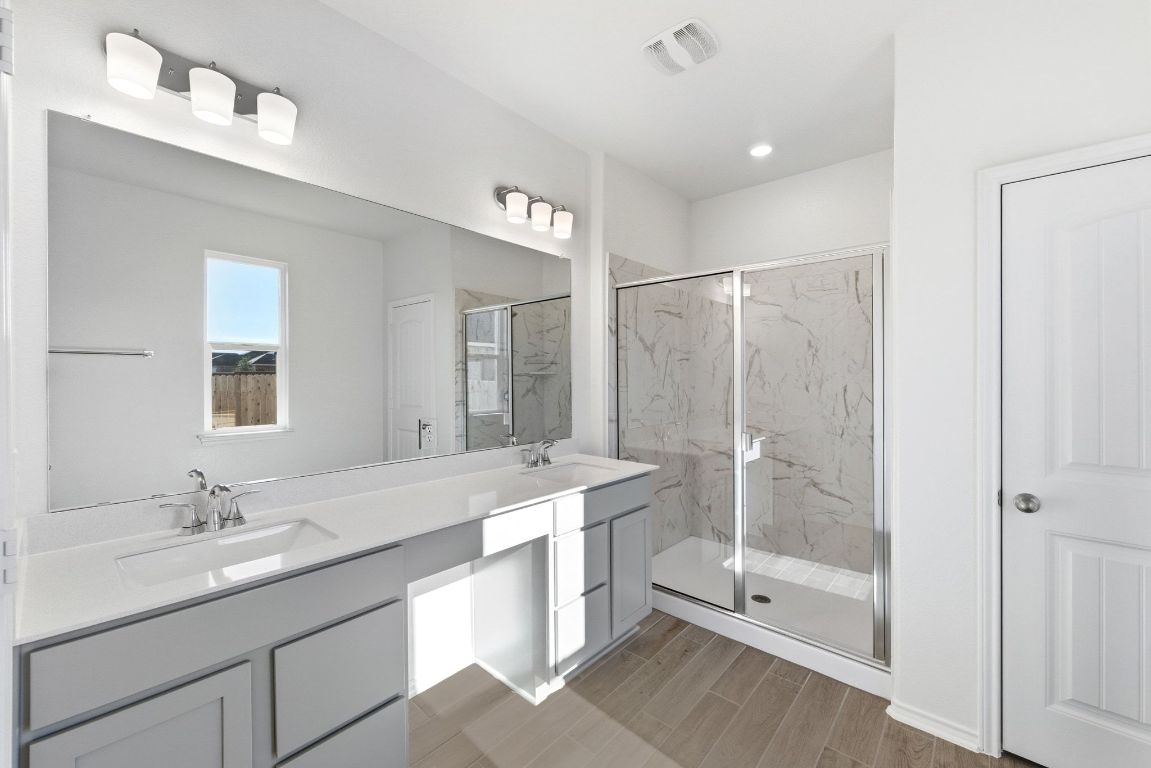 Undisclosed Address Manor, TX 78653 - Photo 21 of 31 a bathroom with a shower sink double vanity and mirror