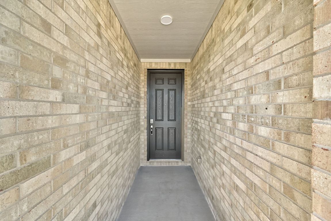 Undisclosed Address Manor, TX 78653 - Photo 3 of 31 a view of a brick room with brick walls
