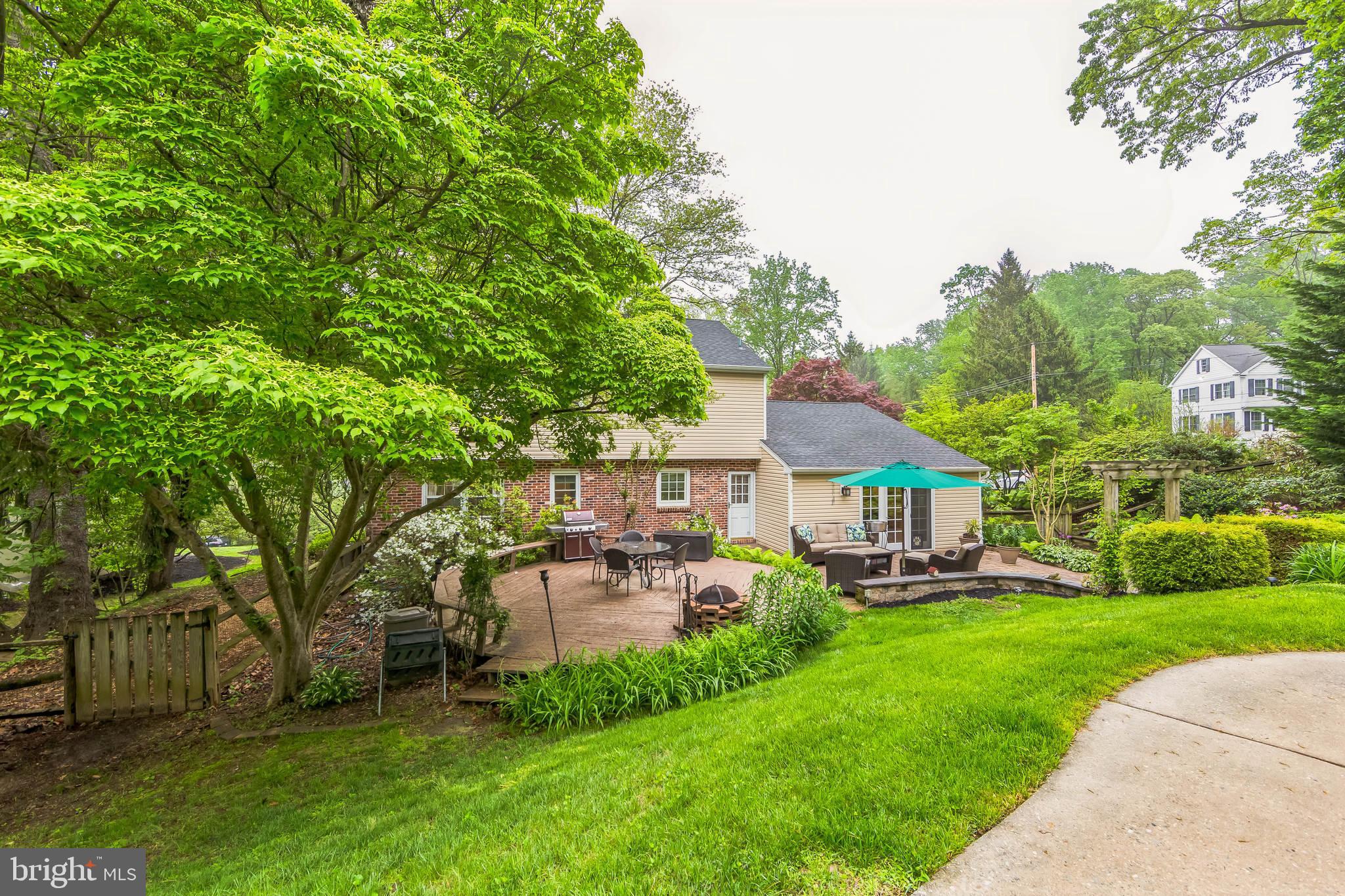 580 Gregory Lane Devon, PA 19333 - Photo 22 of 26 a view of a house with a big yard potted plants and a large tree