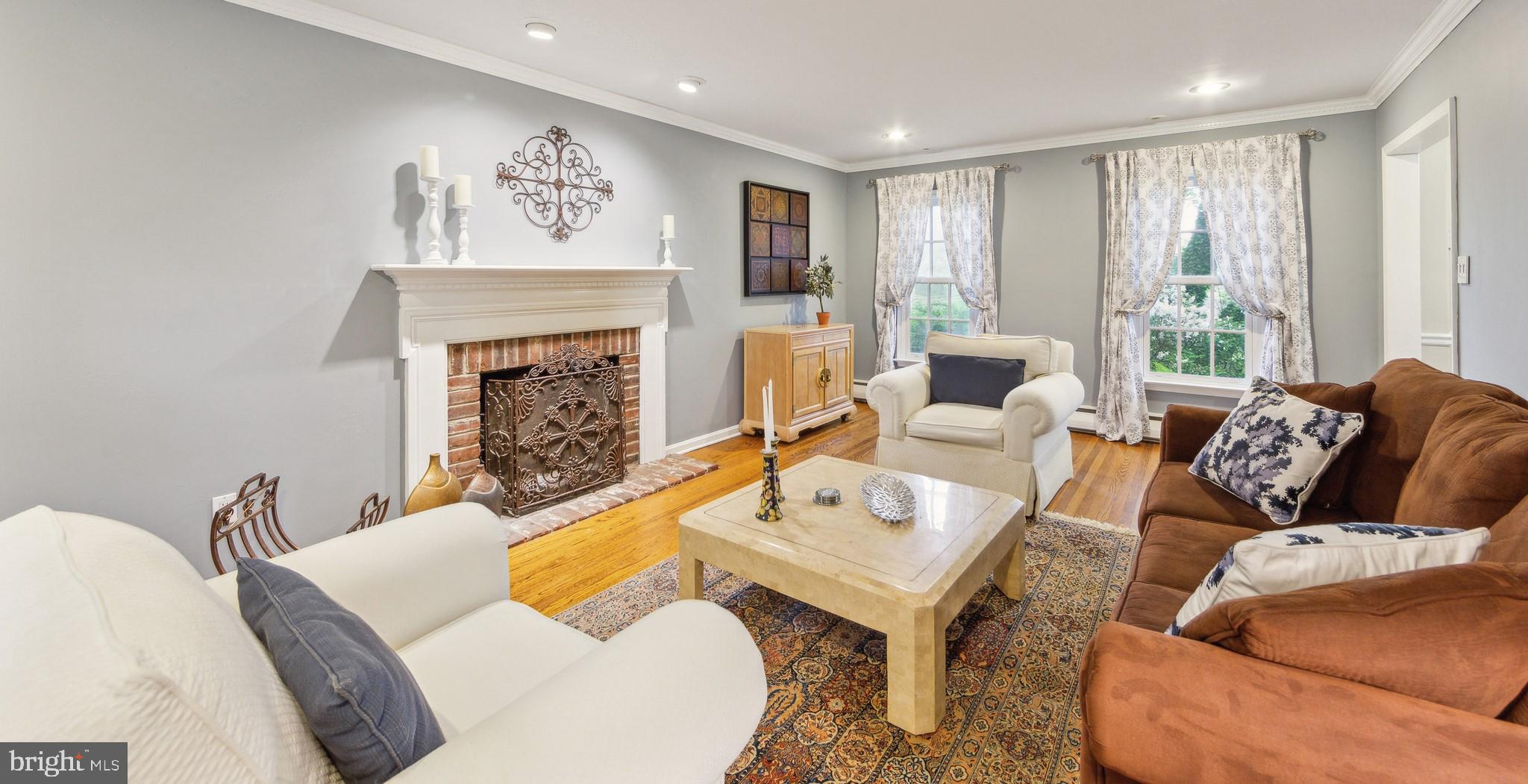 580 Gregory Lane Devon, PA 19333 - Photo 4 of 26 a living room with furniture two window and a fireplace