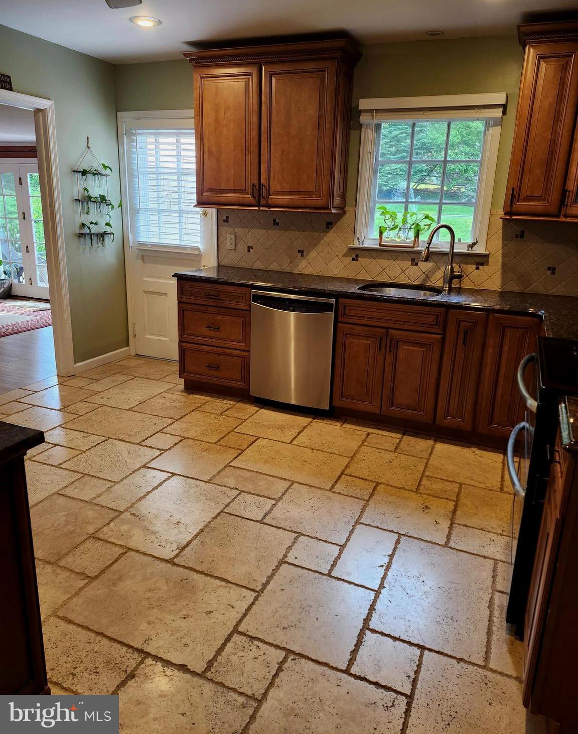 580 Gregory Lane Devon, PA 19333 - Photo 6 of 26 a kitchen with stainless steel appliances a sink a stove a refrigerator cabinets and a window