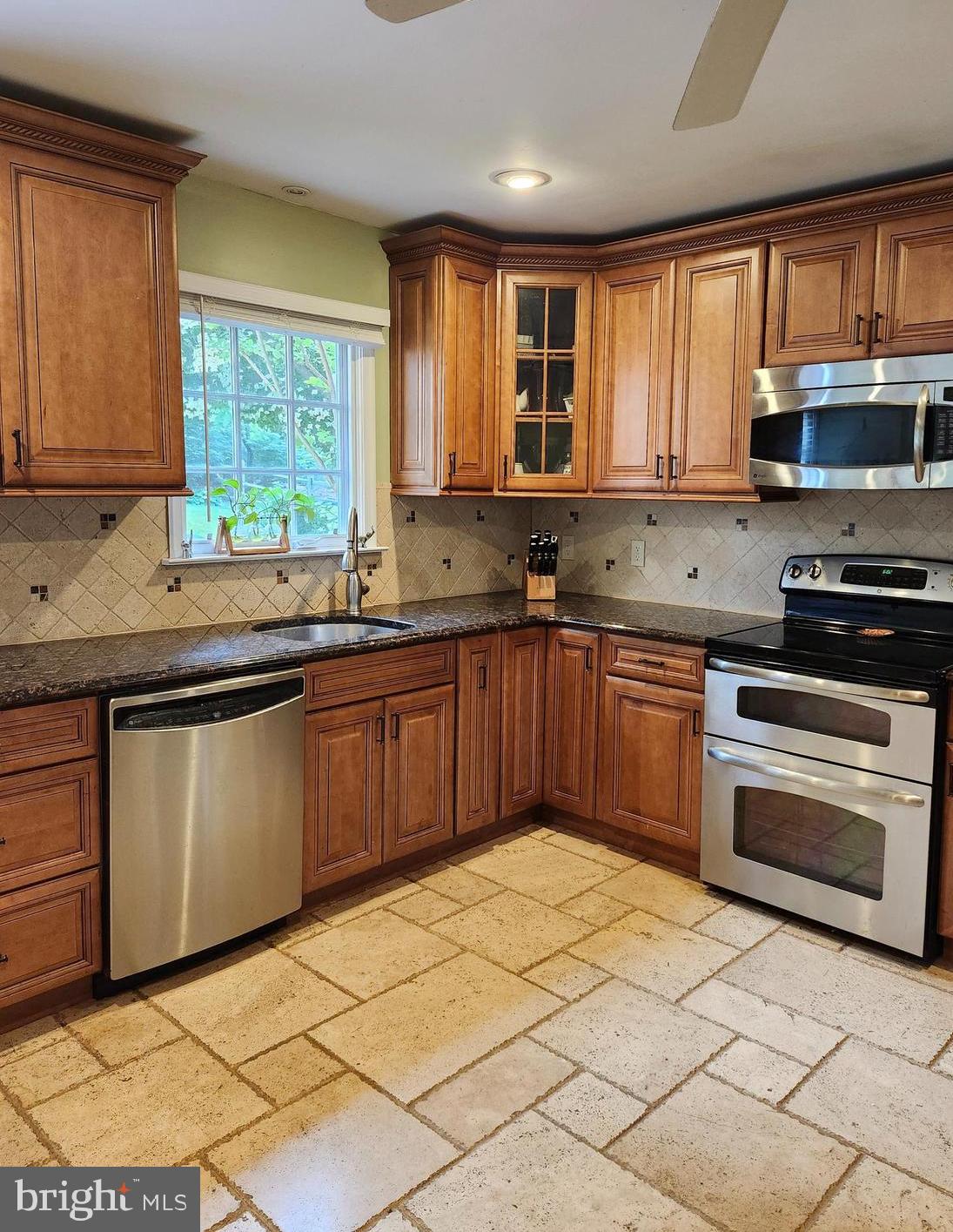 580 Gregory Lane Devon, PA 19333 - Photo 7 of 26 a kitchen with stainless steel appliances granite countertop a stove sink and microwave