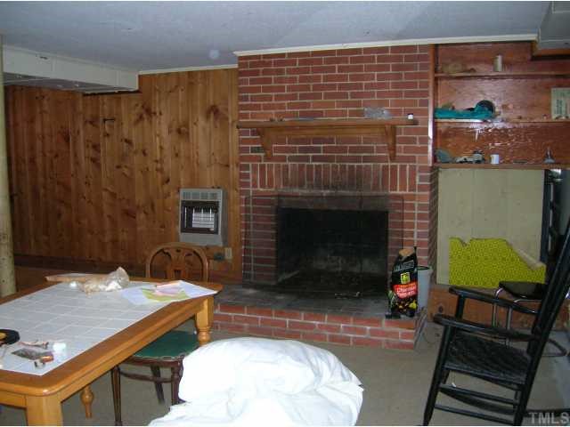 3624 Guess Road Durham, NC 27705 - Photo 8 of 12 Back portion of basement has a fireplace and a wall gas heater.