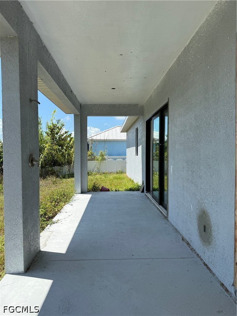 10658 Rainsville Street Port Charlotte, FL 33981 - Photo 19 of 21 a view of a porch with a floor to ceiling window and a yard