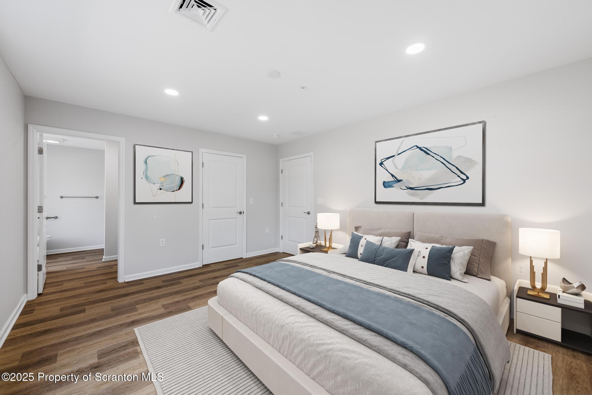 45 Zackery Way Old Forge, PA 18518 - Photo 15 of 26 a spacious bedroom with a bed and painting on the wall