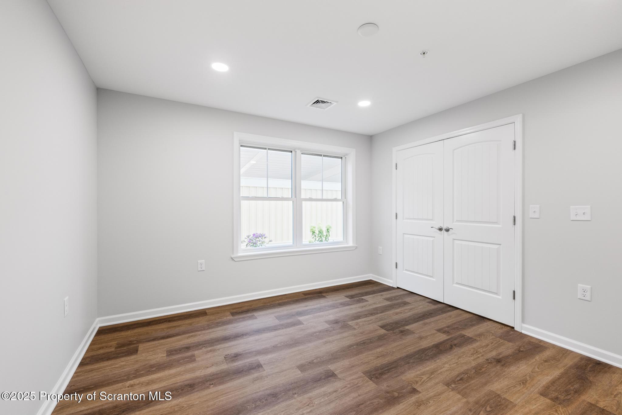 45 Zackery Way Old Forge, PA 18518 - Photo 22 of 26 a view of empty room with wooden floor and fan