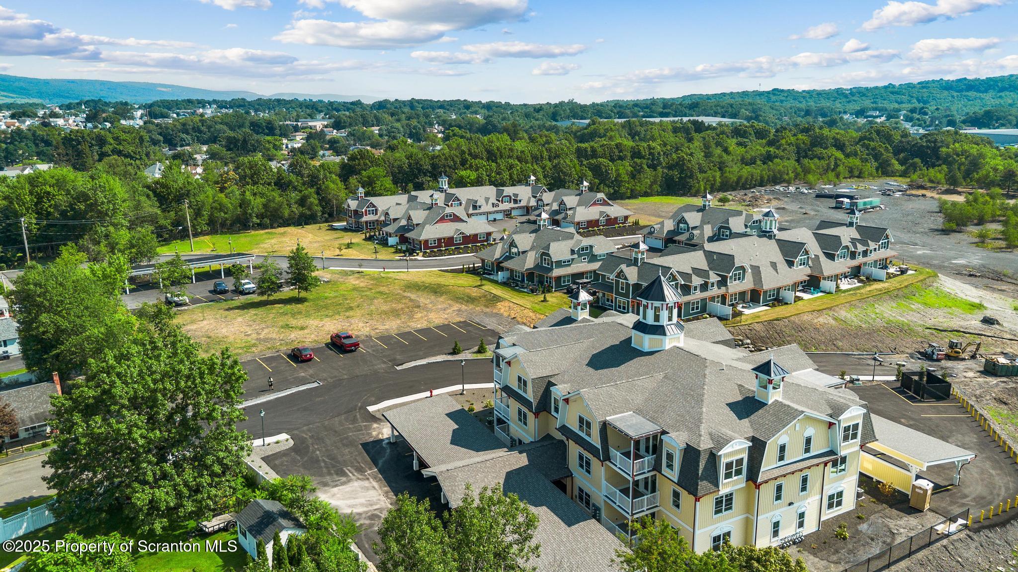 45 Zackery Way Old Forge, PA 18518 - Photo 4 of 26 an aerial view of a house with swimming pool and lake view