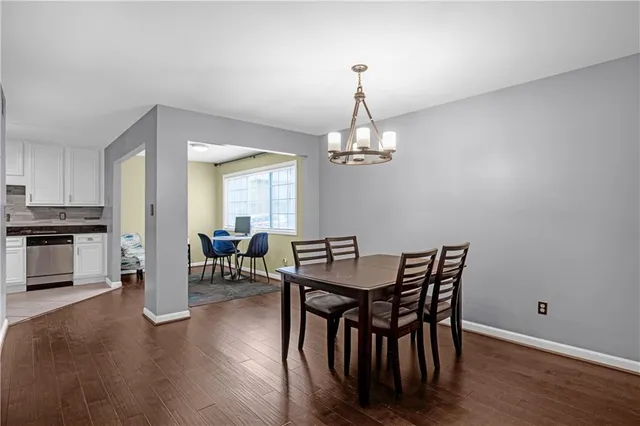 a view of a dining room with furniture and wooden floor