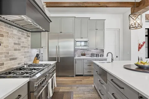 a kitchen with stainless steel appliances granite countertop a sink and cabinets