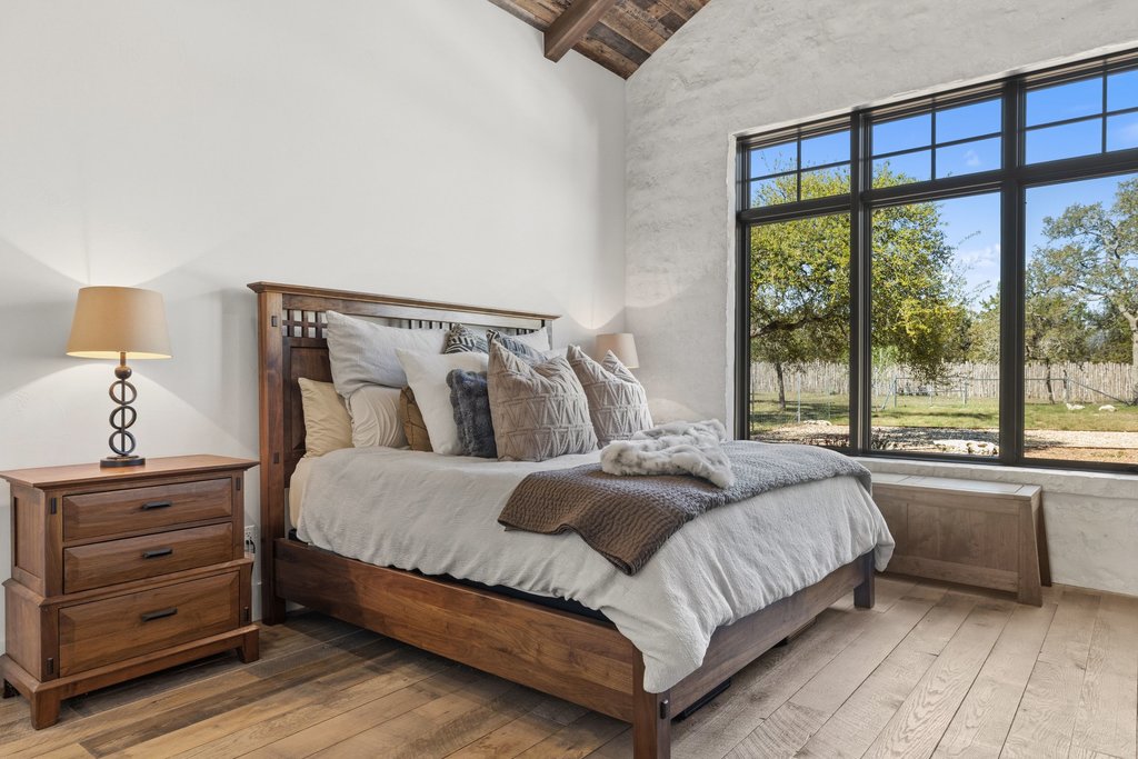 1660 Windmill Run Wimberley, TX 78676 - Photo 12 of 40 a bedroom with a bed and a window