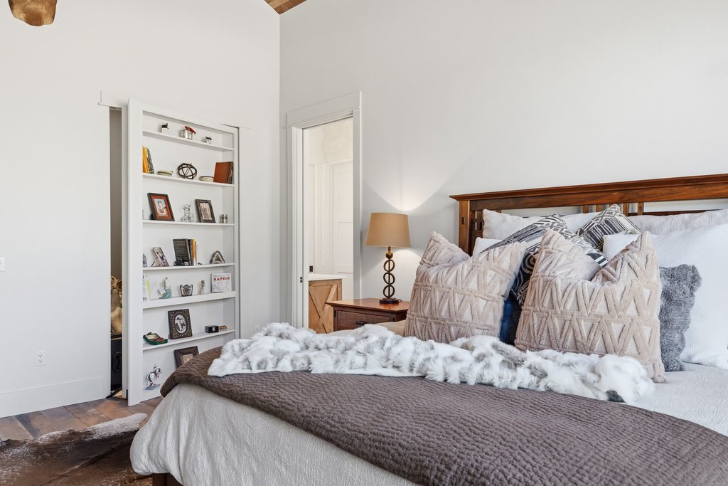 1660 Windmill Run Wimberley, TX 78676 - Photo 13 of 40 a bedroom with a bed and a window