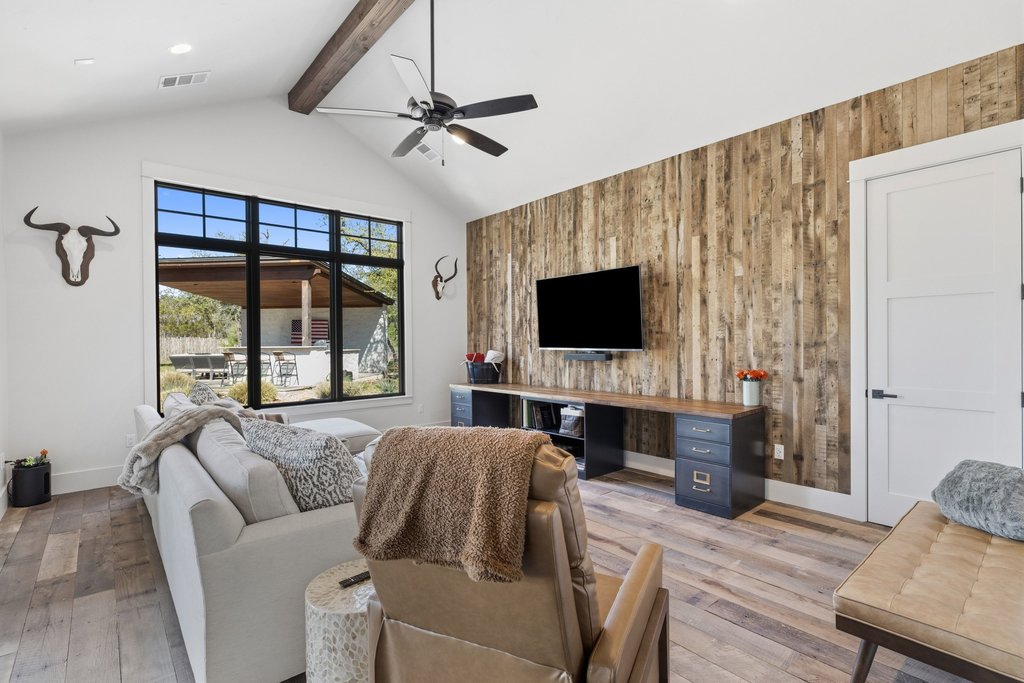 1660 Windmill Run Wimberley, TX 78676 - Photo 17 of 40 a living room with furniture and a flat screen tv