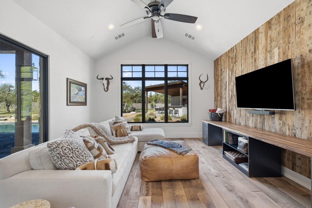 1660 Windmill Run Wimberley, TX 78676 - Photo 18 of 40 a living room with furniture and a flat screen tv