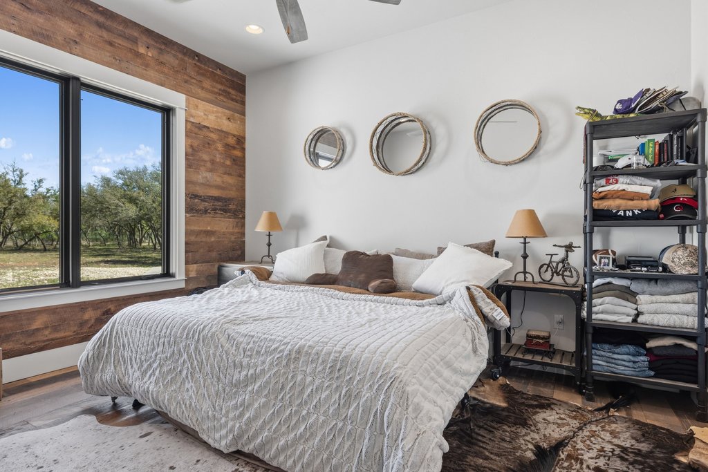 1660 Windmill Run Wimberley, TX 78676 - Photo 21 of 40 a bedroom with bed and a large window