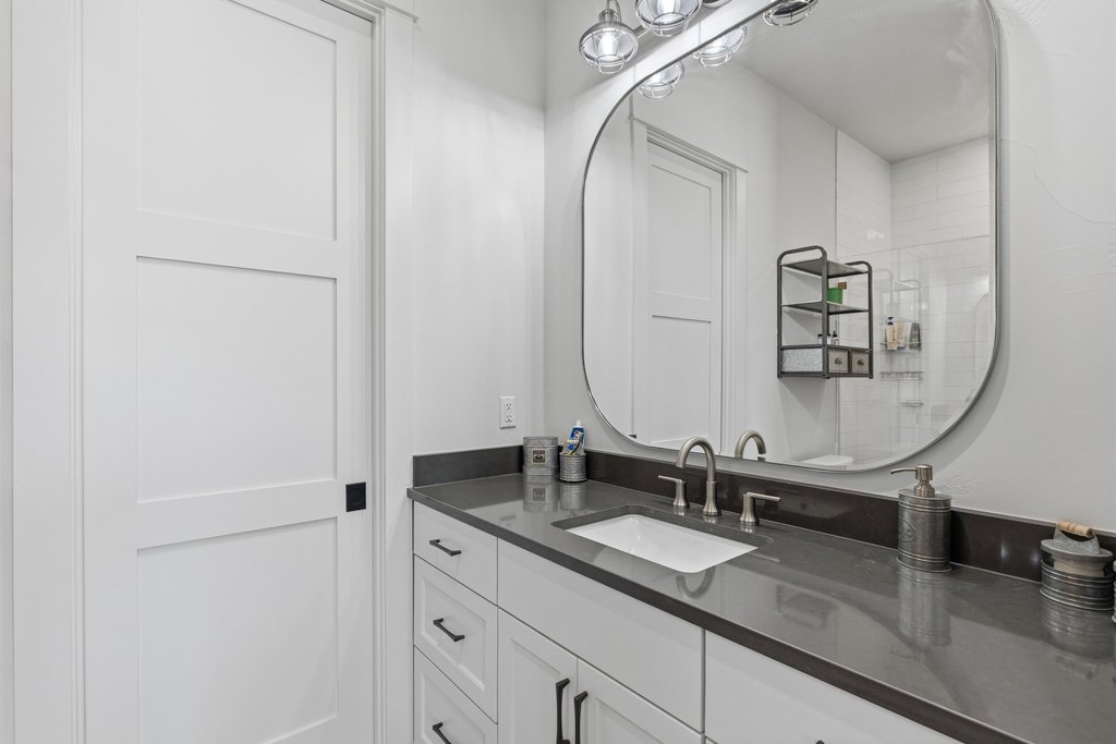 1660 Windmill Run Wimberley, TX 78676 - Photo 22 of 40 a bathroom with double vanity sink and a mirror