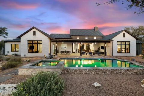 a front view of a house with yard and green space