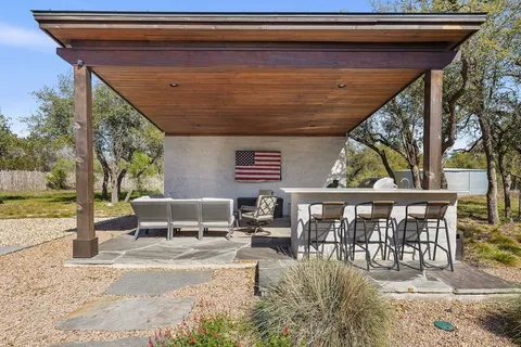 a view of a house with backyard and sitting area