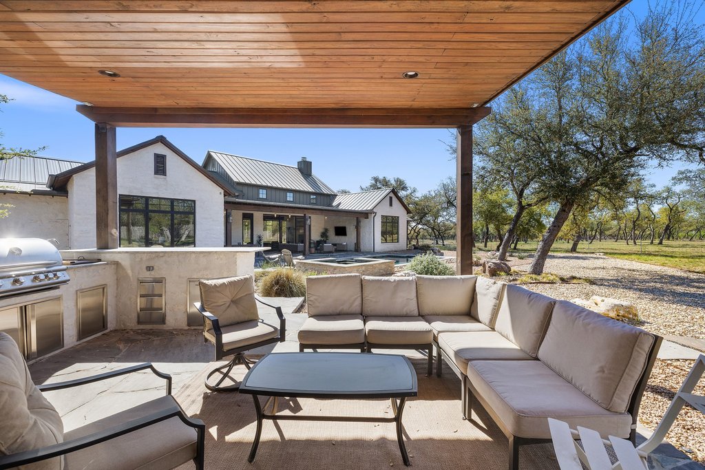 1660 Windmill Run Wimberley, TX 78676 - Photo 32 of 40 a view of living room kitchen with stainless steel appliances wooden floor and seating space