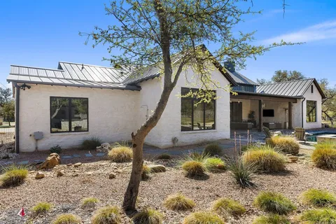 a view of living room kitchen with stainless steel appliances wooden floor and seating space