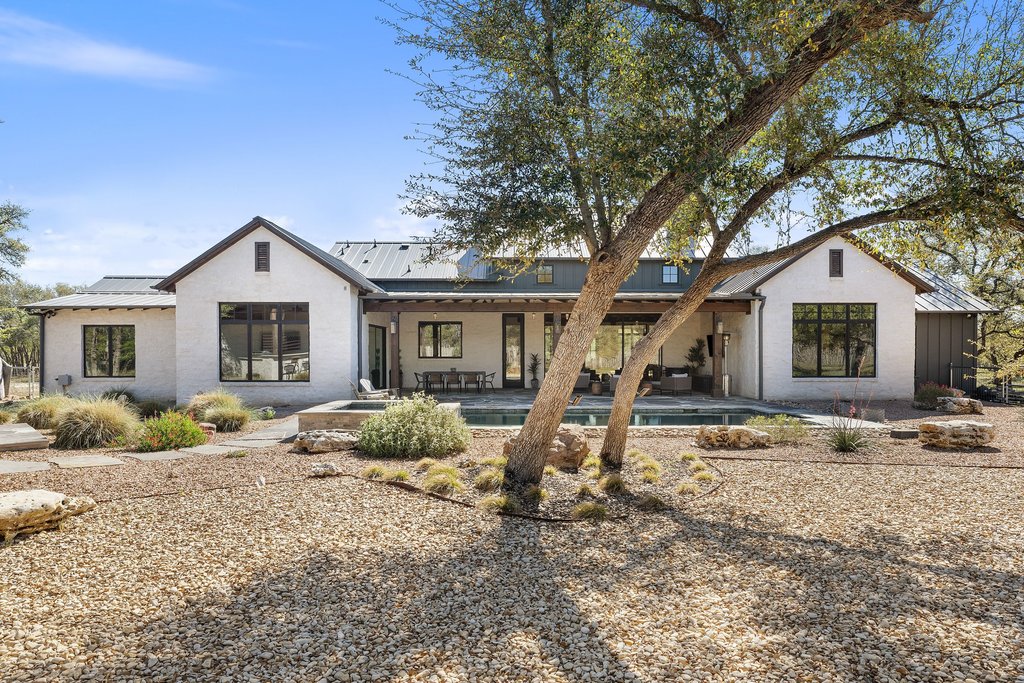 1660 Windmill Run Wimberley, TX 78676 - Photo 34 of 40 a front view of a house with garden
