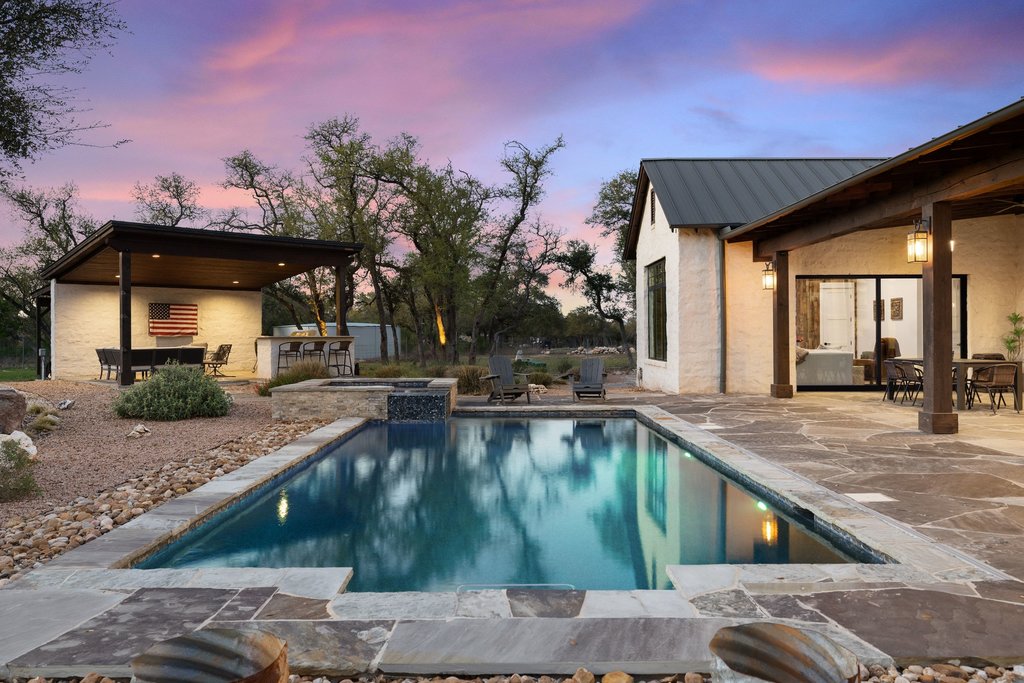 1660 Windmill Run Wimberley, TX 78676 - Photo 35 of 40 a swimming pool with outdoor seating and yard in back