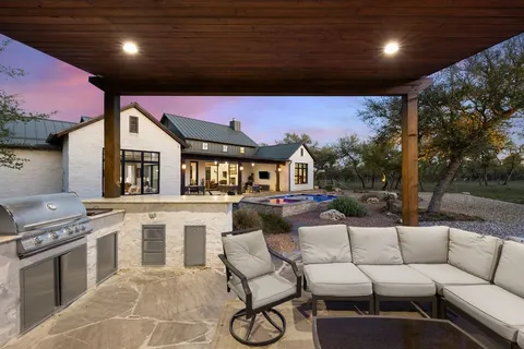 a view of a house with backyard and sitting area