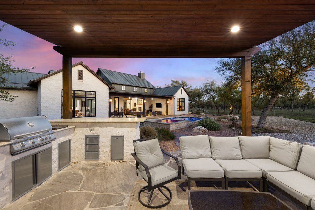 1660 Windmill Run Wimberley, TX 78676 - Photo 37 of 40 a living room with furniture a rug and a fireplace